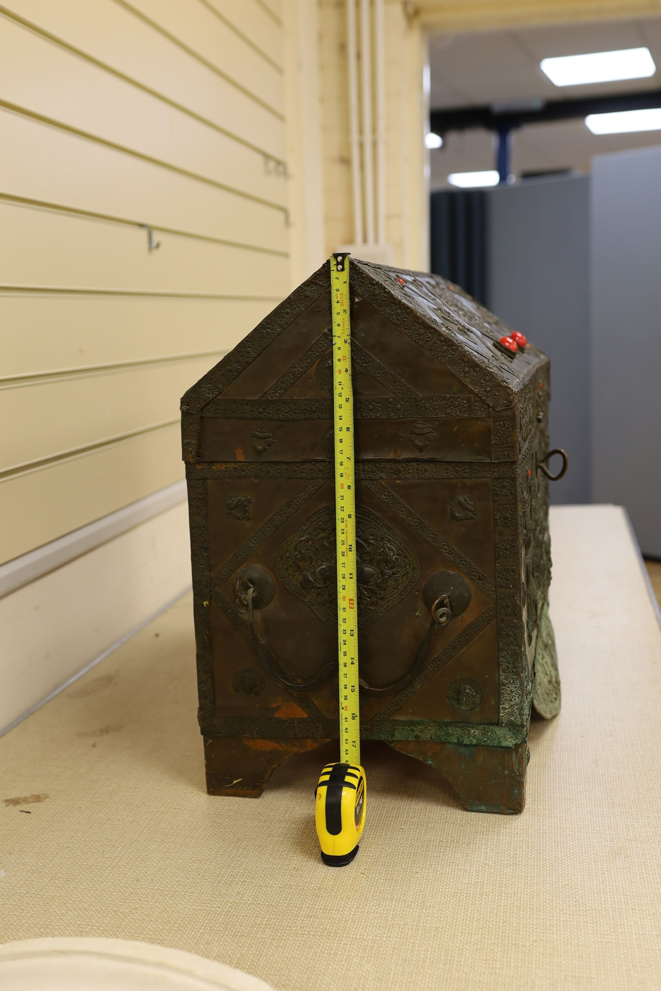 A Tibetan copper repousse-work casket, 20th century, 65cm wide, 49.5cm